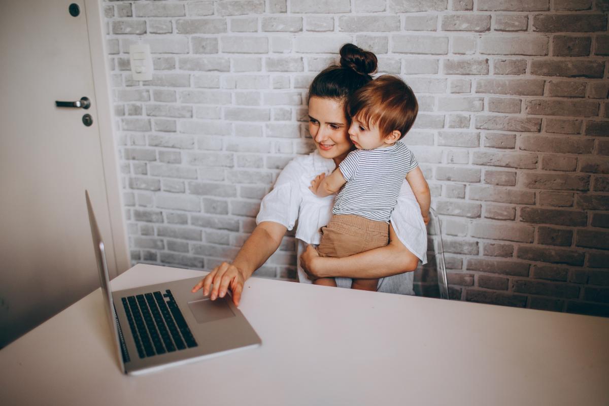 mum holding kid on laptop