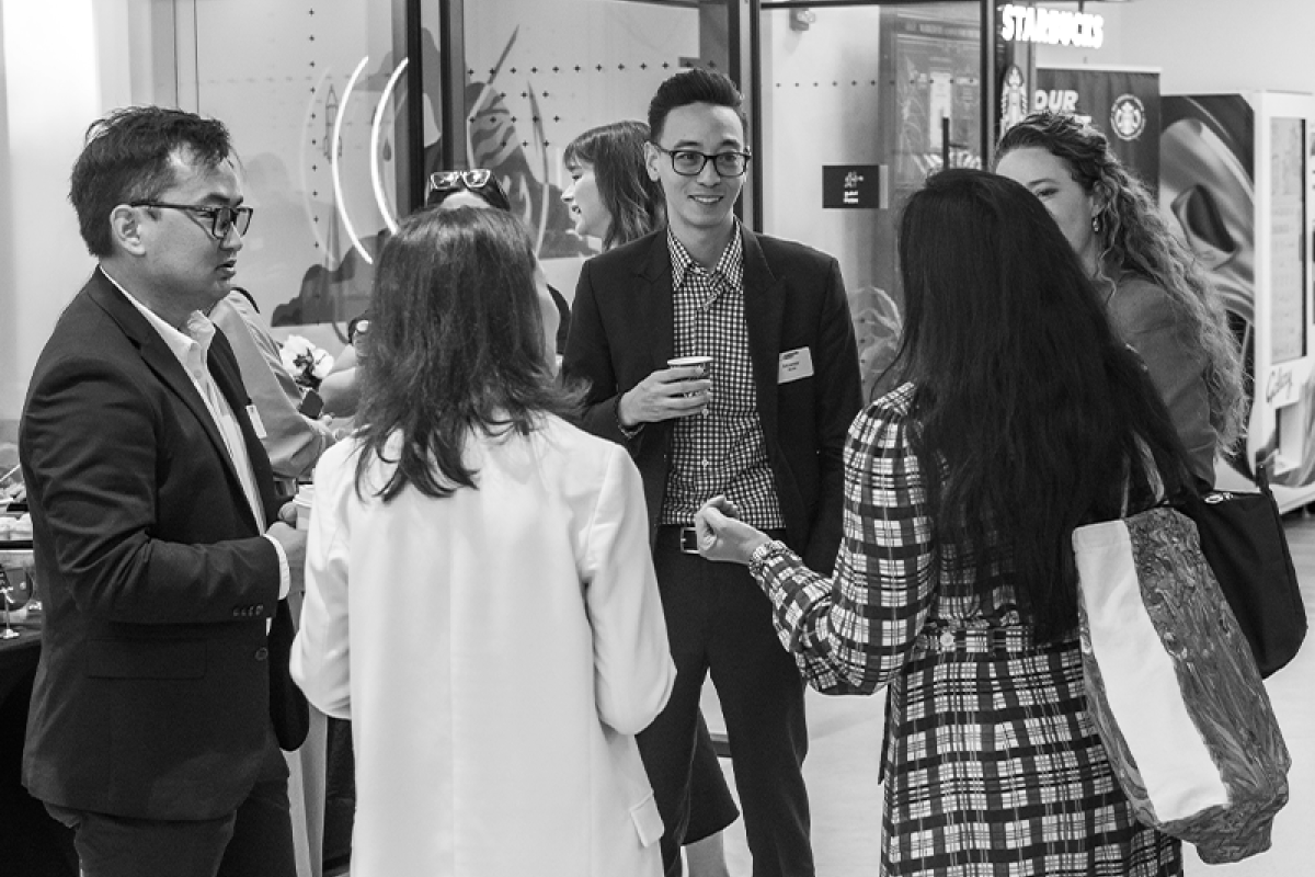 Members standing in a circle talking